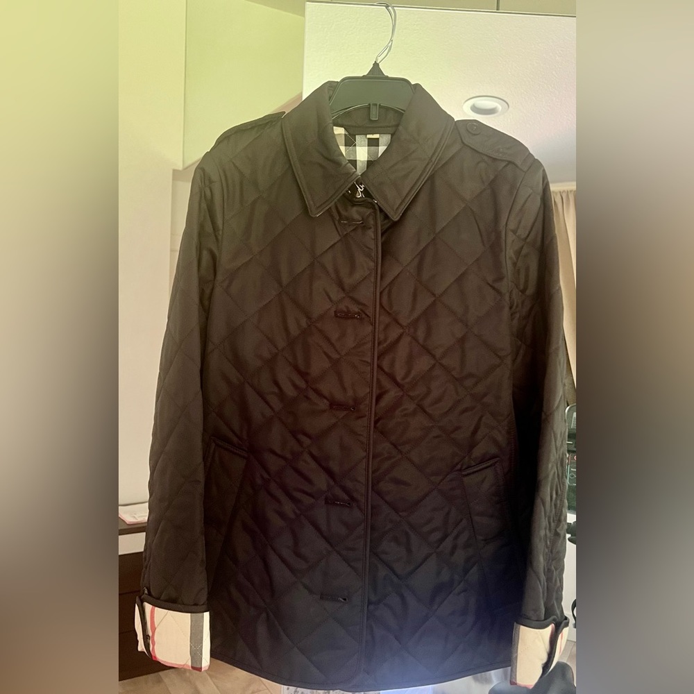 Brand new authentic black Burberry jacket. With the proof of purchase